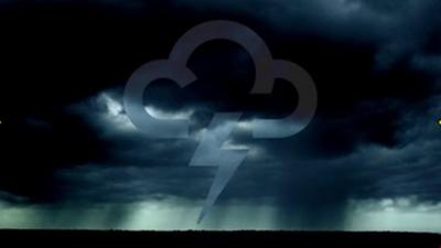 Inky black clouds in the sky with a BBC Weather symbol with a lightning flash in the centre and the ground in silhouette below.