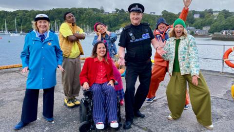 Image of new cast of Balamory looking excited and happy by the side of the harbour.