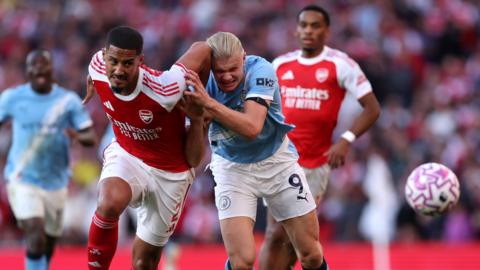 William Saliba battles for possession with Erling Haaland during the Premier League match between Arsenal and Manchester City at Emirates Stadium on September 21, 2025