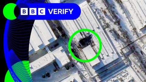 A satellite image of a building with a large hole in it caused by a missile strike