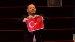 نائب يوناني يمزق العلم التركي