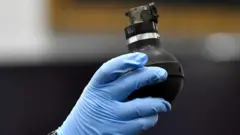 Hand wit glove hold teargas cannister