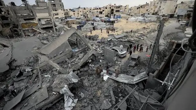 Vue aérienne des destructions : des Palestiniens inspectent un bâtiment détruit à Khan Yunis, à Gaza, le 1er avril 2025.