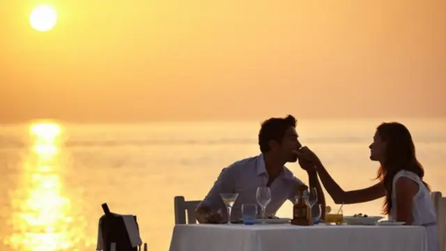 A couple enjoying a romantic dinner on the beach