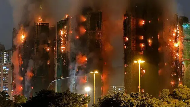 Thick smoke and flames rise as major fire burn several apartment blocks for di Wang Fuk Court residential estate for Hong Kong Tai Po district on November 26, 2025
