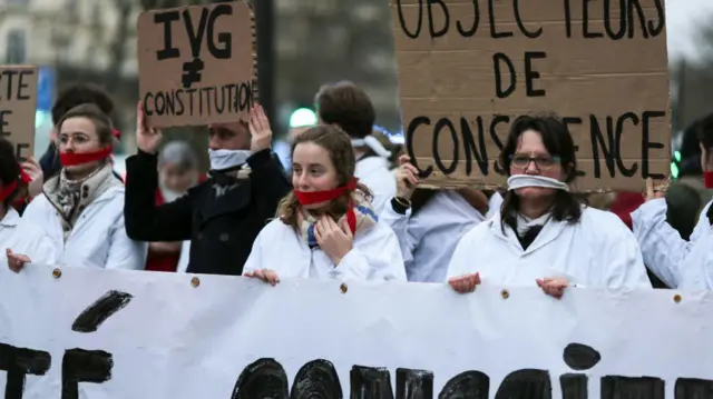 Protesters are taking part in a silent pro-life demonstration with cloths covering their mouths