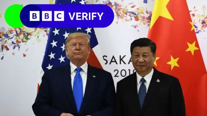 President Donald Trump and President Xi Jinping for one meeting for 2019. US and Chinese flags dey visible for di background and BBC Verify logo dey di top left corner. Trump and Xi bin wear dark suits, wit pins wey represent dia respective nations.