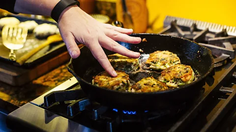 "Bubble and squeak" potato patties fry in a pan (Credit: Getty Images)