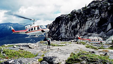Two helicopters landing in Canada's Purcell Mountains dropping off a hiker (Credit: Alamy)