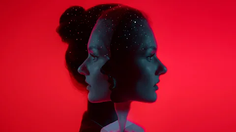Portrait of a woman in profile against a red background duplicated so she is looking left and right (Credit: Getty Images/BBC)
