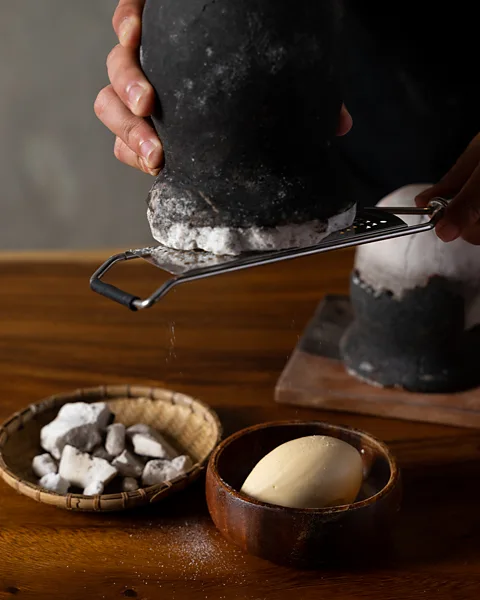 Toyo Eatery Asin tibuok is grated tableside at Michelin-starred restaurant Toyo Eatery in Manila (Credit: Toyo Eatery)