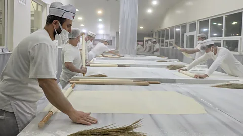 Jen Rose Smith Bakers at İmam Çağdaș roll dough into sheets thin enough to see through for baklava (Credit: Jen Rose Smith)