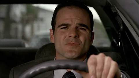 HBO In the episode's opening scene, FBI agent Ron Goddard (Michael Kelly) quotes essayist HL Mencken as his partner vomits (Credit: HBO)