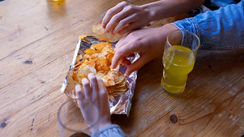 Getty Images Pub snacks set in the middle of the table are generally understood to be for sharing (Credit: Getty Images)