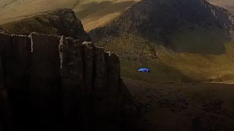 White Giant Josh Beinn in parachute