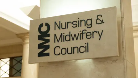 A sign which reads "Nursing and Midwifery Council", engraved on a beige, stone column.