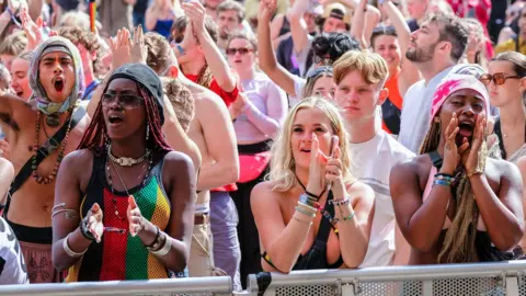 Getty Images Crowds of people enjoy live music at Boomtown Fair Festival in the South Downs National Park, near Winchester, Hampshire
