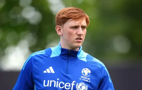 Angry Ginge in a UNICEF football training top