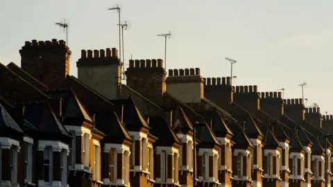 PA Media A row of terraced brick houses with chimneys and television aerials.