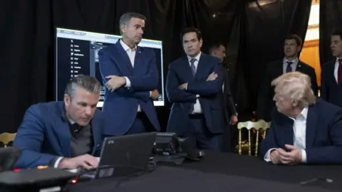 Donald Trump / TruthSocial From left to right: Defence secretary Pete Hegseth, CIA director John Ratcliffe, Rubio and Trump infront of a screen showing posts from X