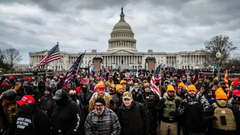 pro-Trump protesters, including Proud Boys leader Joe Biggs, (plaid shirt at bottom center of frame,) gather in front of the U.S. Capitol Building on January 6, 2021 in Washington, DC.