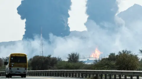 AFP via Getty Images Smoke and flames rise from an energy installation in the Gulf emirate of Fujairah on March 14, 2026.