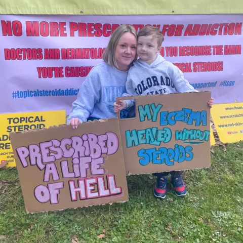 @bee.thebrave Bethany Norman and her son hold placards at a protest against the use of steroids.