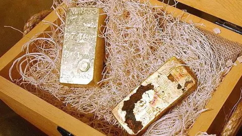 large gold bars inside a wooden case