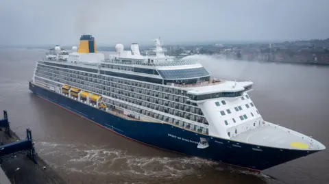 A view from a high vantage point, looking down on Spirit of Discovery as the ship leaves Tilbury on a misty day