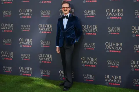 Reuters Composer Tom Fletcher attends the 2026 Olivier Awards at the Royal Albert Hall in London, Britain, April 12, 2026.
