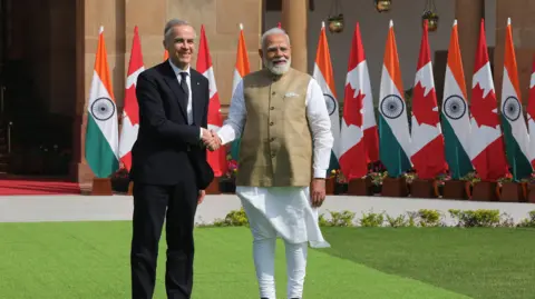 EPA Indian Prime Minister Narendra Modi (R) shakes hands with Canadian Prime Minister Mark Carney (L) in New Delhi, India, 02 March 2026. 