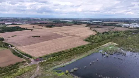 Universal Studios / Comcast Aerial view of the future Universal site in Bedford. It is at this stage several fields and large lakes.