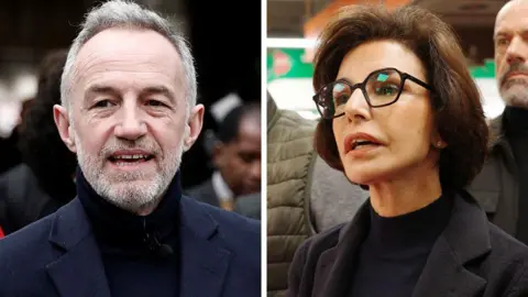 A man with a white beard and black polar-neck stands on the left and on the right a woman with brown hair and glasses