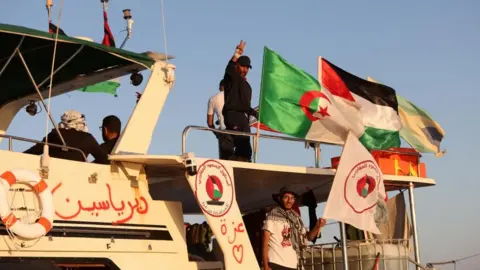 Crew interacts from aboard a boat, part of the Global Sumud Flotilla 